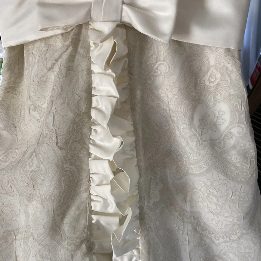 Custom made ivory tone on tone sleeveless dress with satin ruffle and bow. - Picture 2 of 7